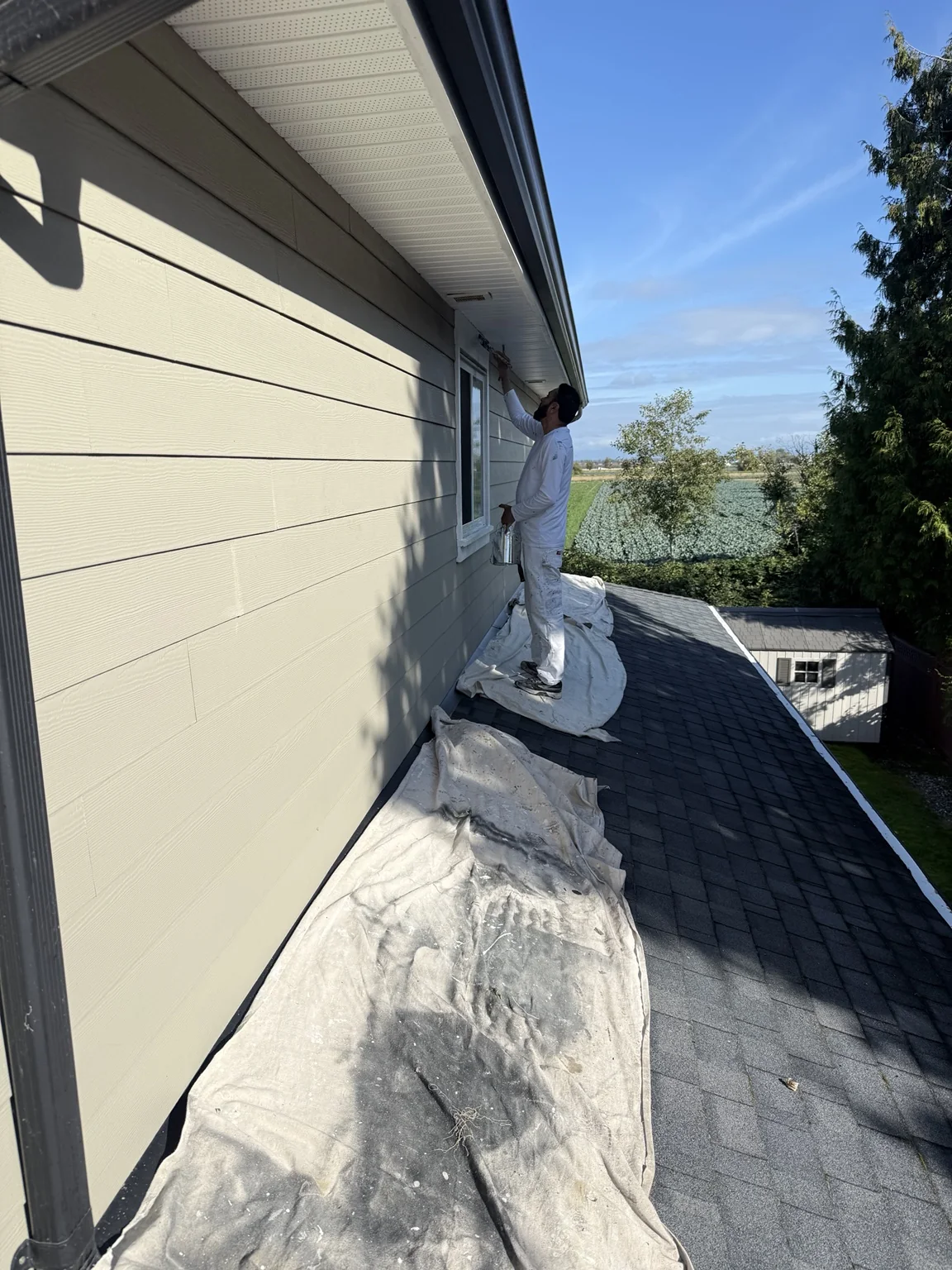 FaithPro painter working on exterior trim
